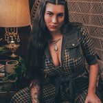 Knit plaid diva jumpsuit with contrasting denim front pockets, collar, and belt, blending retro 70's charm with bold, modern flair.