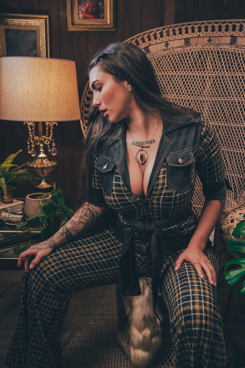 Knit plaid diva jumpsuit with contrasting denim front pockets, collar, and belt, blending retro 70's charm with bold, modern flair.