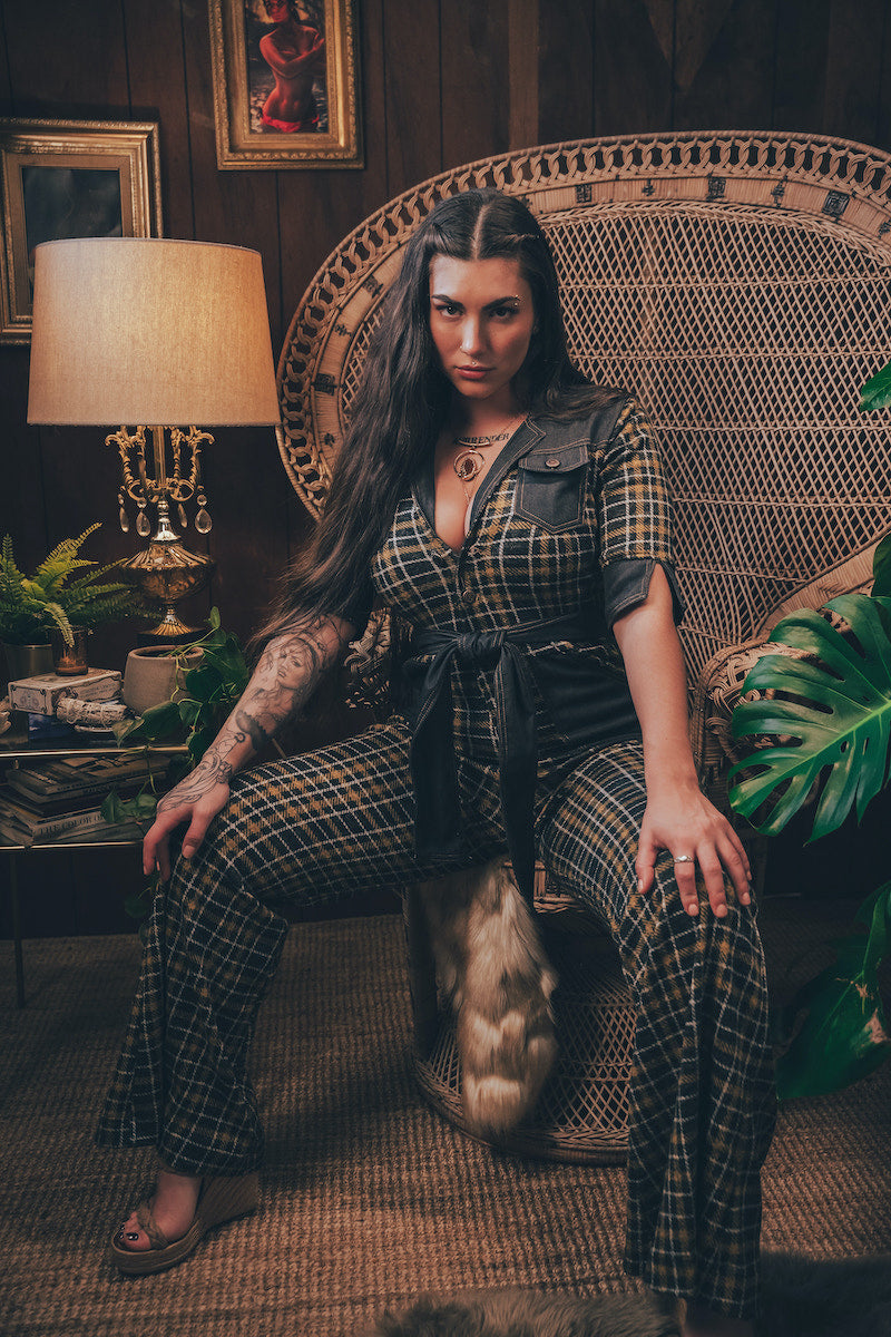 Knit plaid diva jumpsuit with contrasting denim front pockets, collar, and belt, blending retro 70's charm with bold, modern flair.