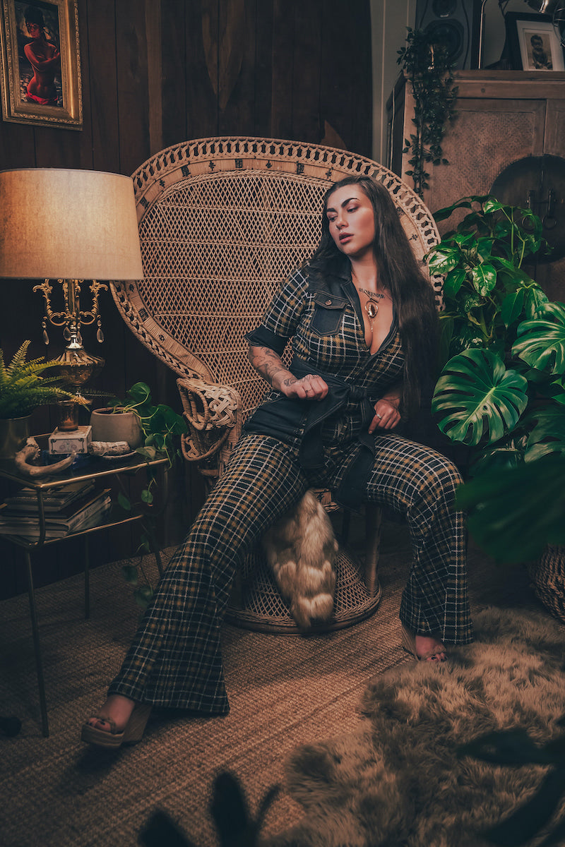 Knit plaid diva jumpsuit with contrasting denim front pockets, collar, and belt, blending retro 70's charm with bold, modern flair.
