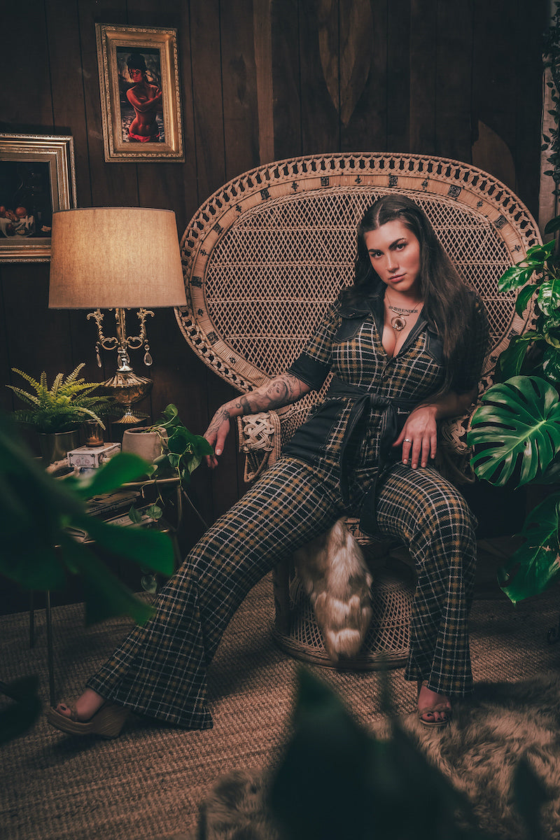 Knit plaid diva jumpsuit with contrasting denim front pockets, collar, and belt, blending retro 70's charm with bold, modern flair.