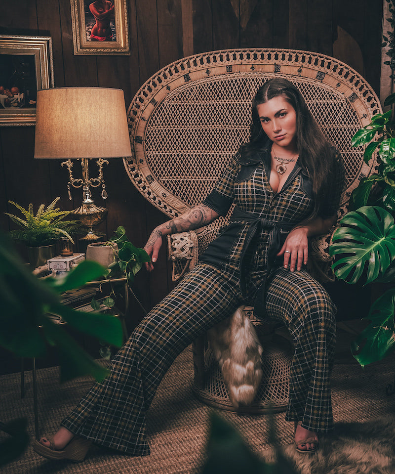 Knit plaid diva jumpsuit with contrasting denim front pockets, collar, and belt, blending retro 70's charm with bold, modern flair.