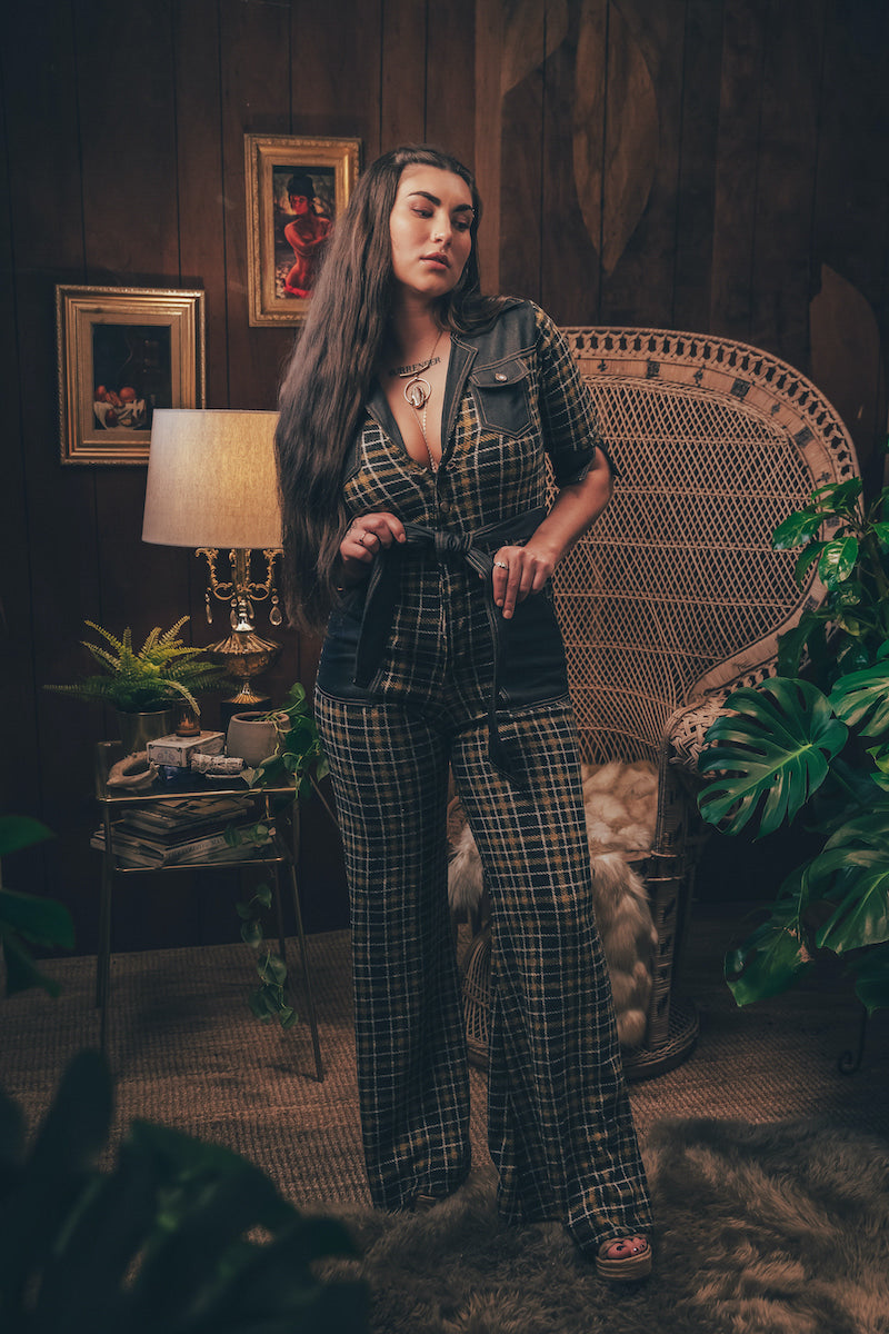 Knit plaid diva jumpsuit with contrasting denim front pockets, collar, and belt, blending retro 70's charm with bold, modern flair.