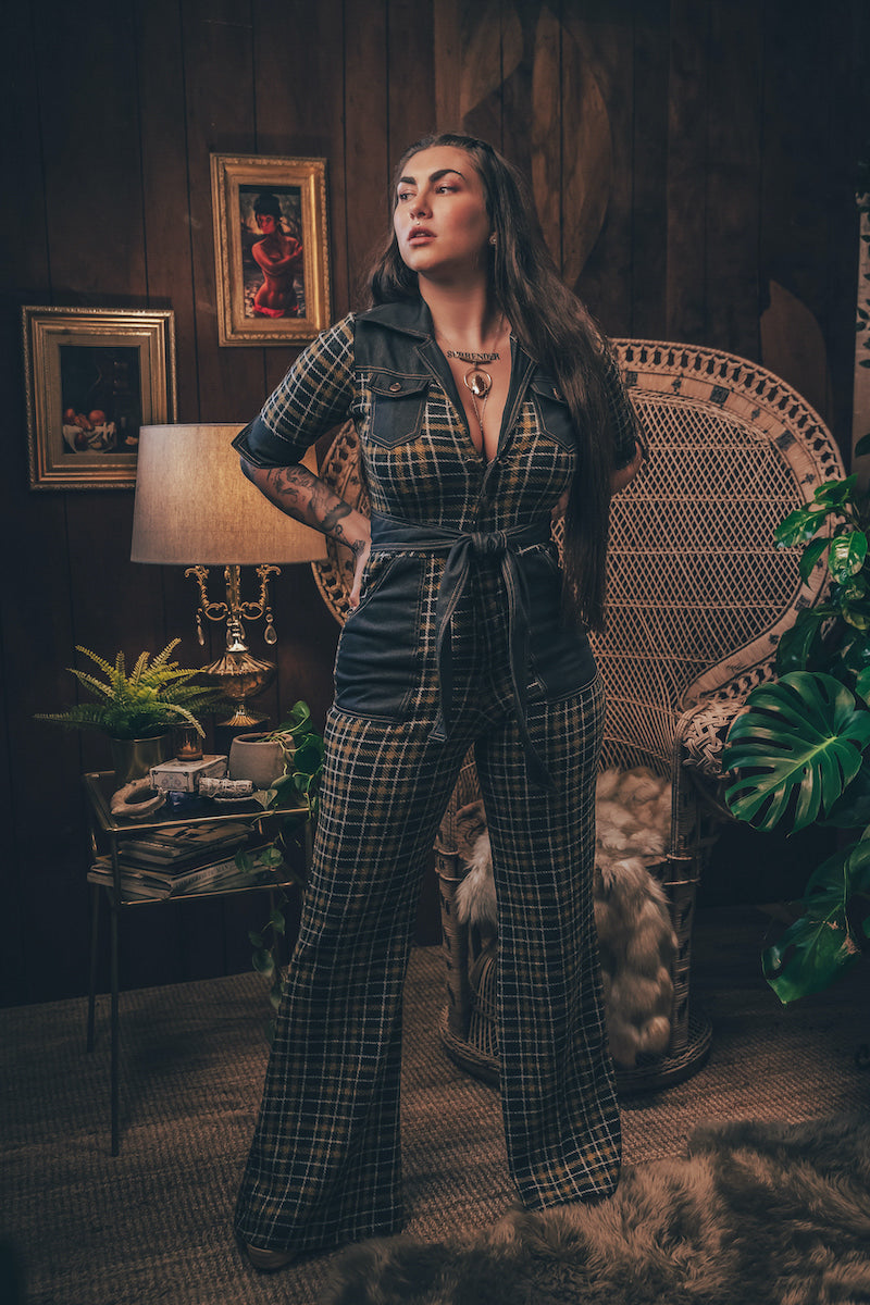 Knit plaid diva jumpsuit with contrasting denim front pockets, collar, and belt, blending retro 70's charm with bold, modern flair.