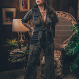 Knit plaid diva jumpsuit with contrasting denim front pockets, collar, and belt, blending retro 70's charm with bold, modern flair.