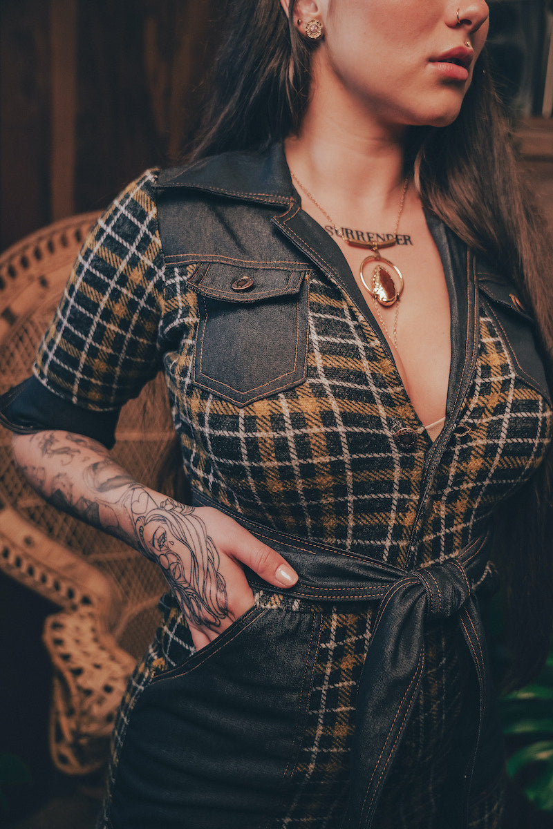 Knit plaid diva jumpsuit with contrasting denim front pockets, collar, and belt, blending retro 70's charm with bold, modern flair.