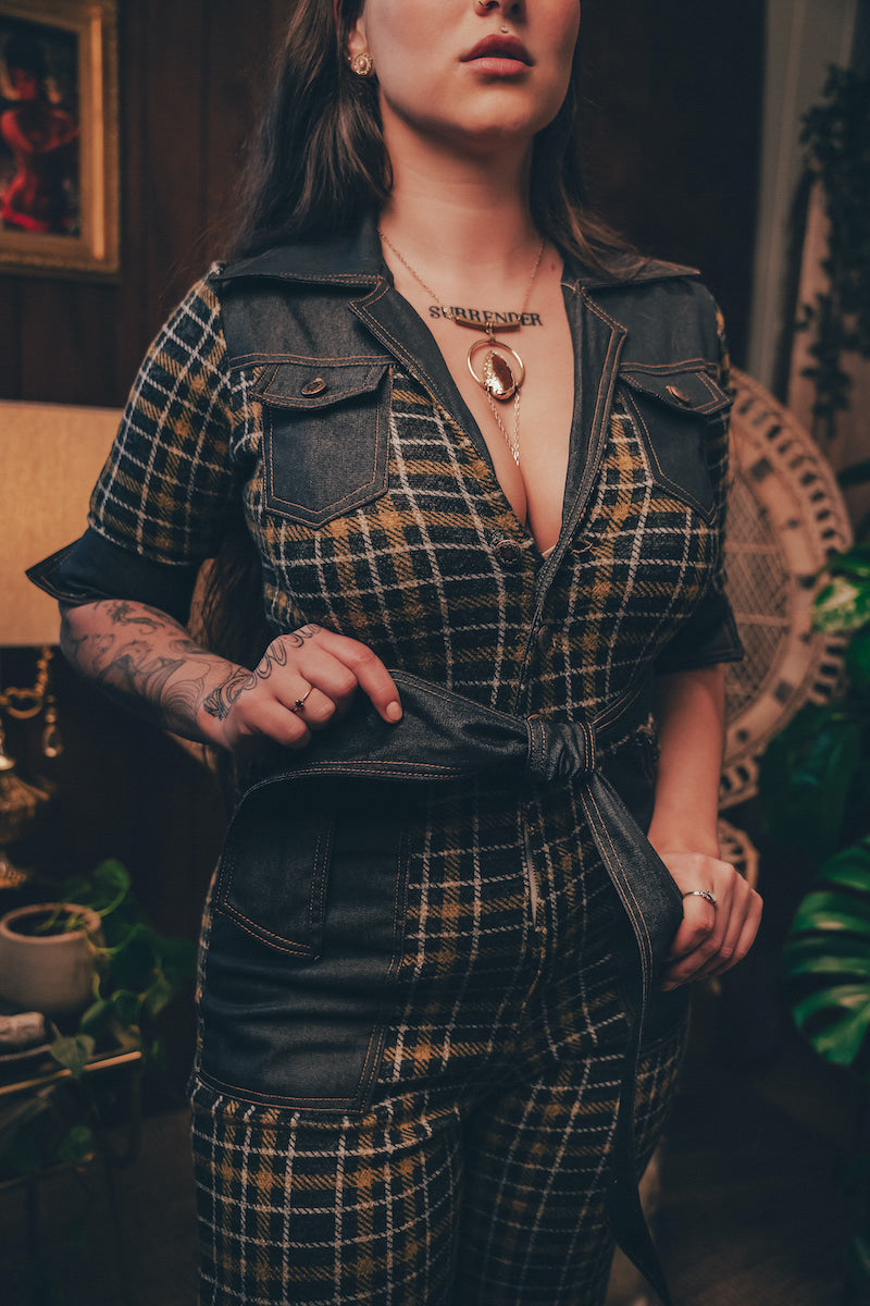 Knit plaid diva jumpsuit with contrasting denim front pockets, collar, and belt, blending retro 70's charm with bold, modern flair.