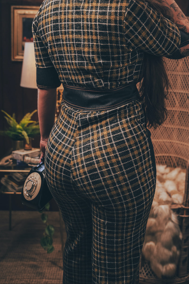 Knit plaid diva jumpsuit with contrasting denim front pockets, collar, and belt, blending retro 70's charm with bold, modern flair.