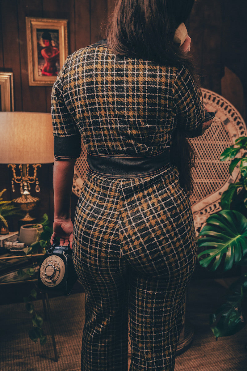 Knit plaid diva jumpsuit with contrasting denim front pockets, collar, and belt, blending retro 70's charm with bold, modern flair.