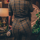 Knit plaid diva jumpsuit with contrasting denim front pockets, collar, and belt, blending retro 70's charm with bold, modern flair.