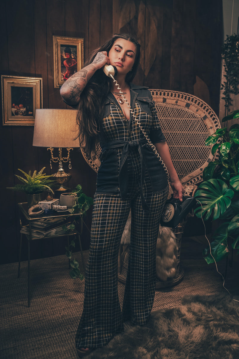 Knit plaid diva jumpsuit with contrasting denim front pockets, collar, and belt, blending retro 70's charm with bold, modern flair.