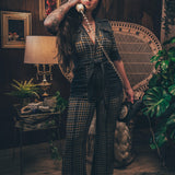 Knit plaid diva jumpsuit with contrasting denim front pockets, collar, and belt, blending retro 70's charm with bold, modern flair.