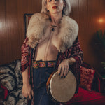 Beautiful woman wears bell bottom jeans in a 1970s retro living room
