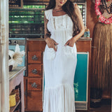 Soul Sister since 1969 long white dress on beautiful woman with a fringe shawl and retro floppy hat standing in a vintage trailer