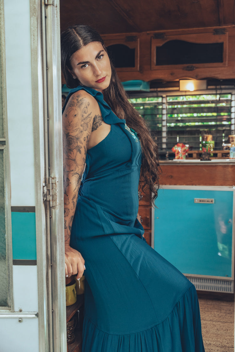 long flowy teal boho maxi dress with open back and ruffle details
