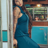long flowy teal boho maxi dress with open back and ruffle details
