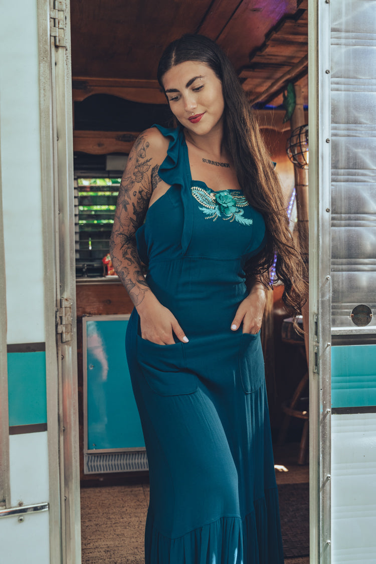 beautiful bohemian embroidered blue dress on woman in a retro trailer