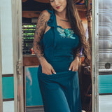beautiful bohemian embroidered blue dress on woman in a retro trailer