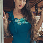 beautiful bohemian embroidered blue dress on woman in a retro trailer