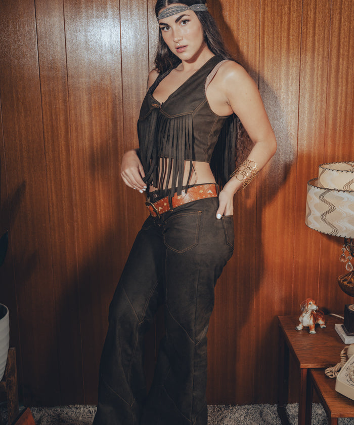 gorgeous groovy woman looks like she's going to wood stock or in a 70's funk band wearing leather patchwork bell bottoms by Soul Sister since 1969
