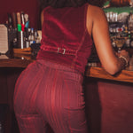 Person wearing a red outfit standing at a bar counter.