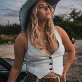 Woman in a white top and blue jeans with a cowboy hat standing next to a car outdoors wearing Soul Sister since 1969..
