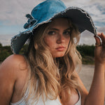 Woman wearing a blue denim hat outdoors with a natural background Wearing Soul Sister since 1969