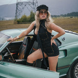 Woman posing next to a vintage car with a scenic background wearing Soul Sister since 1969