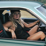 Woman sitting in a car with scenic background wearing Soul Sister since 1969