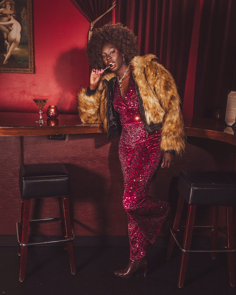 Our Soul Sister muse wears an iconic 1970s inspired faux fur bomber style coat worthy of studio '54 disco parties.