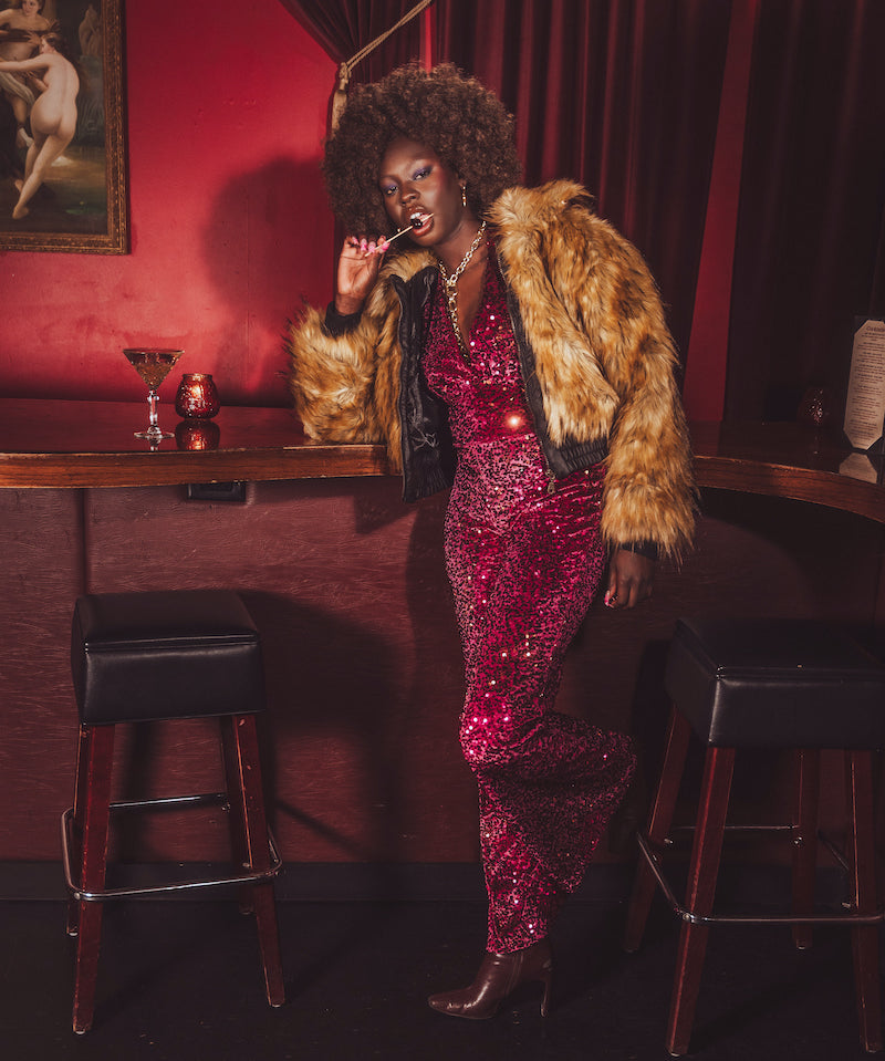 Our Soul Sister muse wears an iconic 1970s inspired faux fur bomber style coat worthy of studio '54 disco parties.
