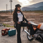 Woman in a desert setting with a motorcycle and suitcases, wearing a 'Ride or Die' t-shirt wearing Soul Sister since 1969.