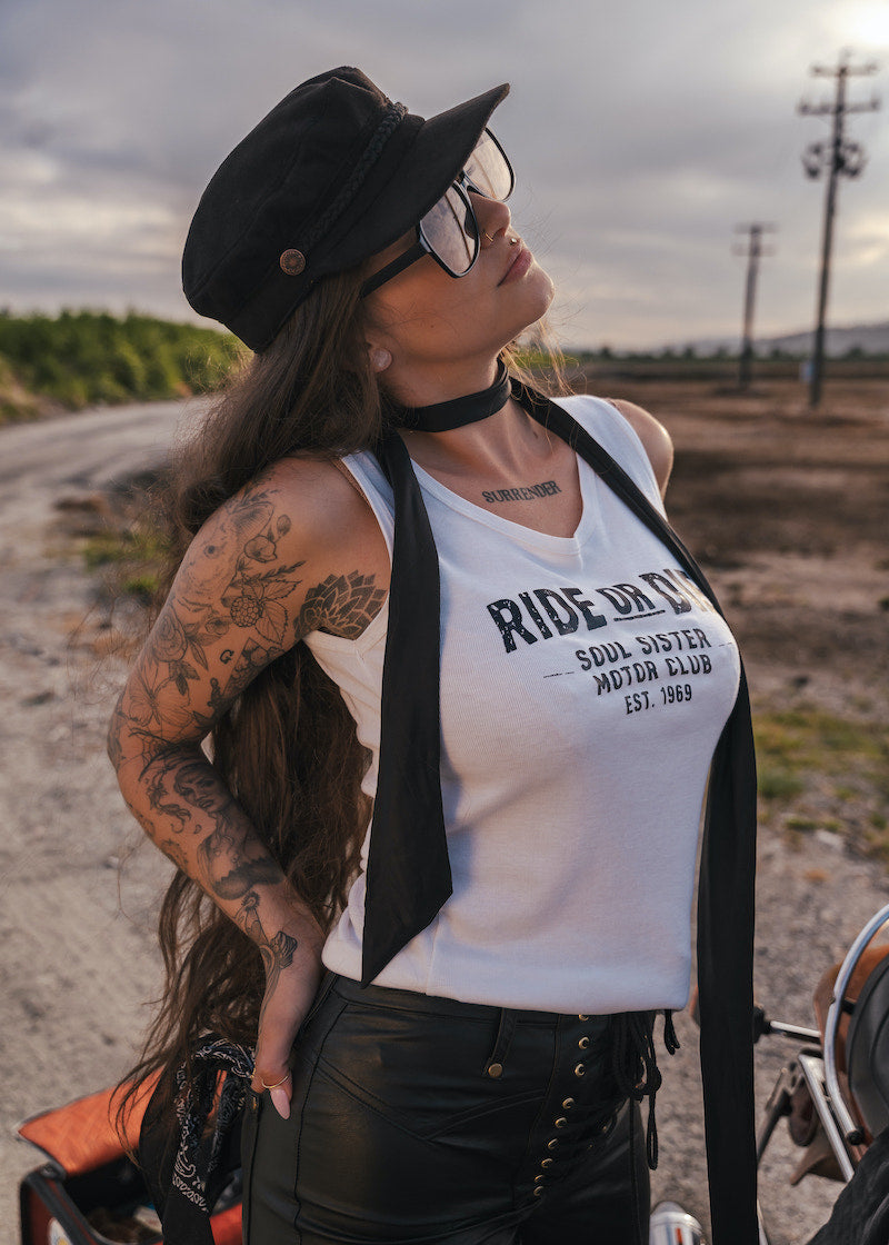 Woman wearing a 'Ride or Die' tank top in an outdoor setting wearing Soul Sister since 1969.