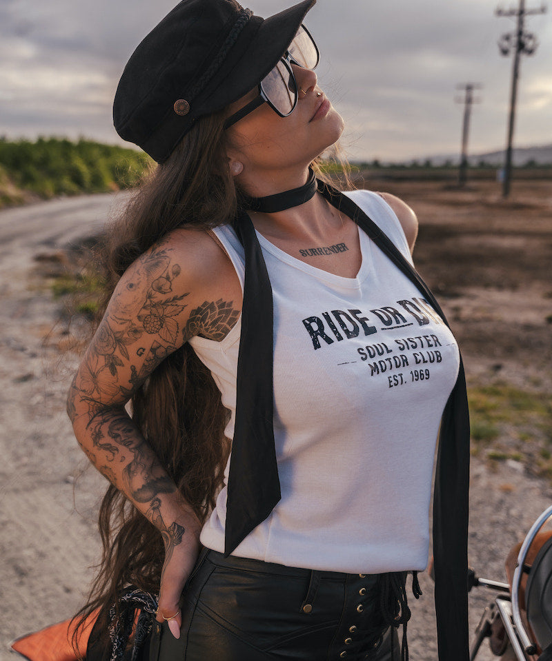 Woman wearing a 'Ride or Die' tank top in an outdoor setting wearing Soul Sister since 1969.