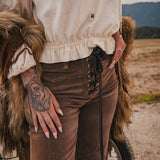 Person wearing a fur coat and brown pants with a scenic background wearing Soul Sister since 1969