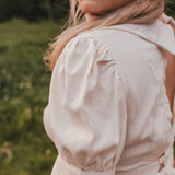 Woman wearing a beige blouse with puffed sleeves in a natural setting wearing Soul Sister since 1969